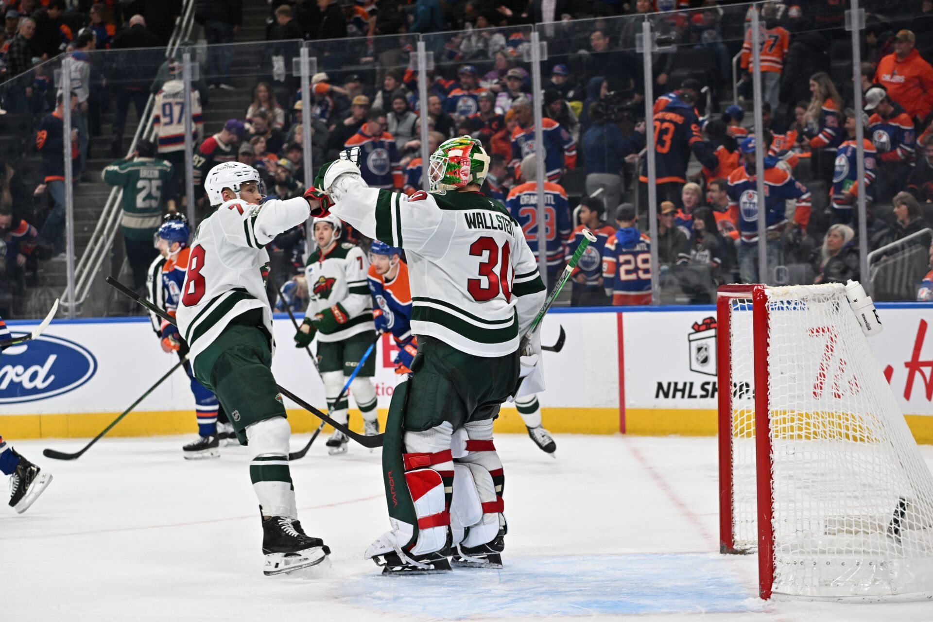 Minnesota Wild center Nico Sturm (78) and goalie Jesper Wallstedt (30) celebrate their win during the third period at Rogers Place.