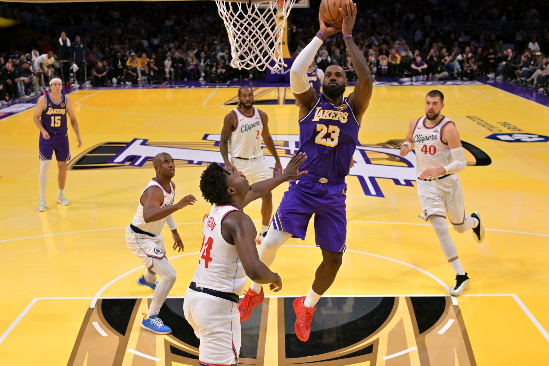 Los Angeles Lakers forward LeBron James (23) gets past Los Angeles Clippers guard Chris Paul (3), forward Kawhi Leonard (2), center Ivica Zubac (40) and guard Kobe Brown (24) for a basket in the second half at Crypto.com Arena.