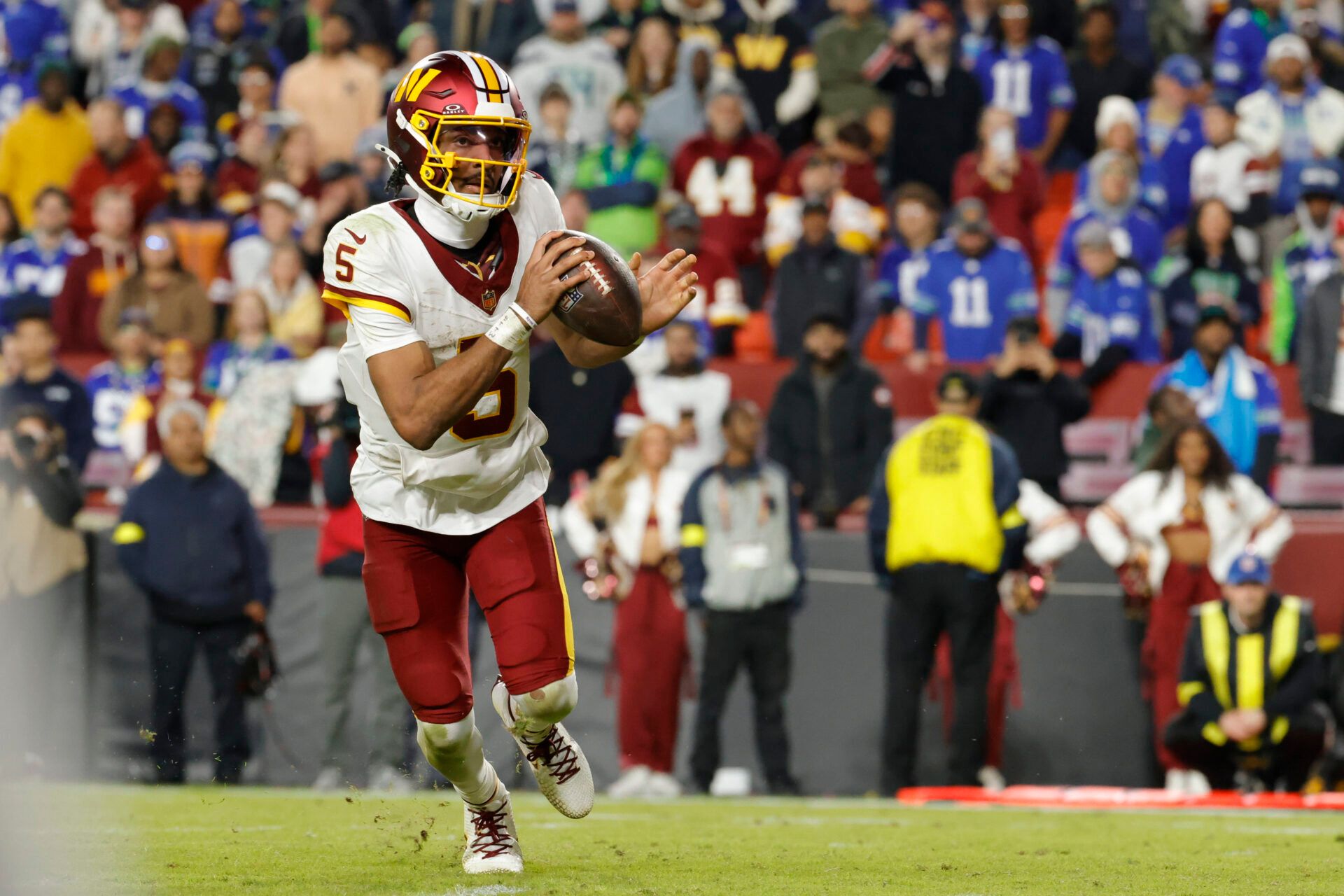 Washington Commanders quarterback Jayden Daniels (5) runs the ball during the second half against the Seattle Seahawks at Northwest Stadium.