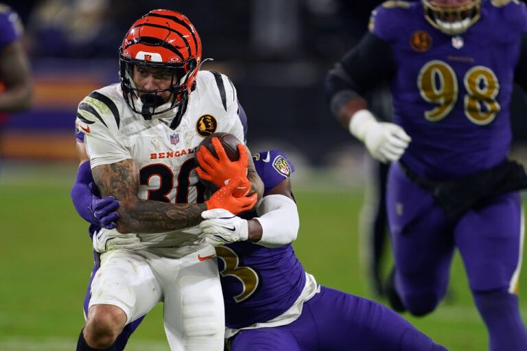 Cincinnati Bengals running back Chase Brown (30) rushed the ball against Baltimore Ravens cornerback Chidobe Awuzie (3) during the second half at M&T Bank Stadium.