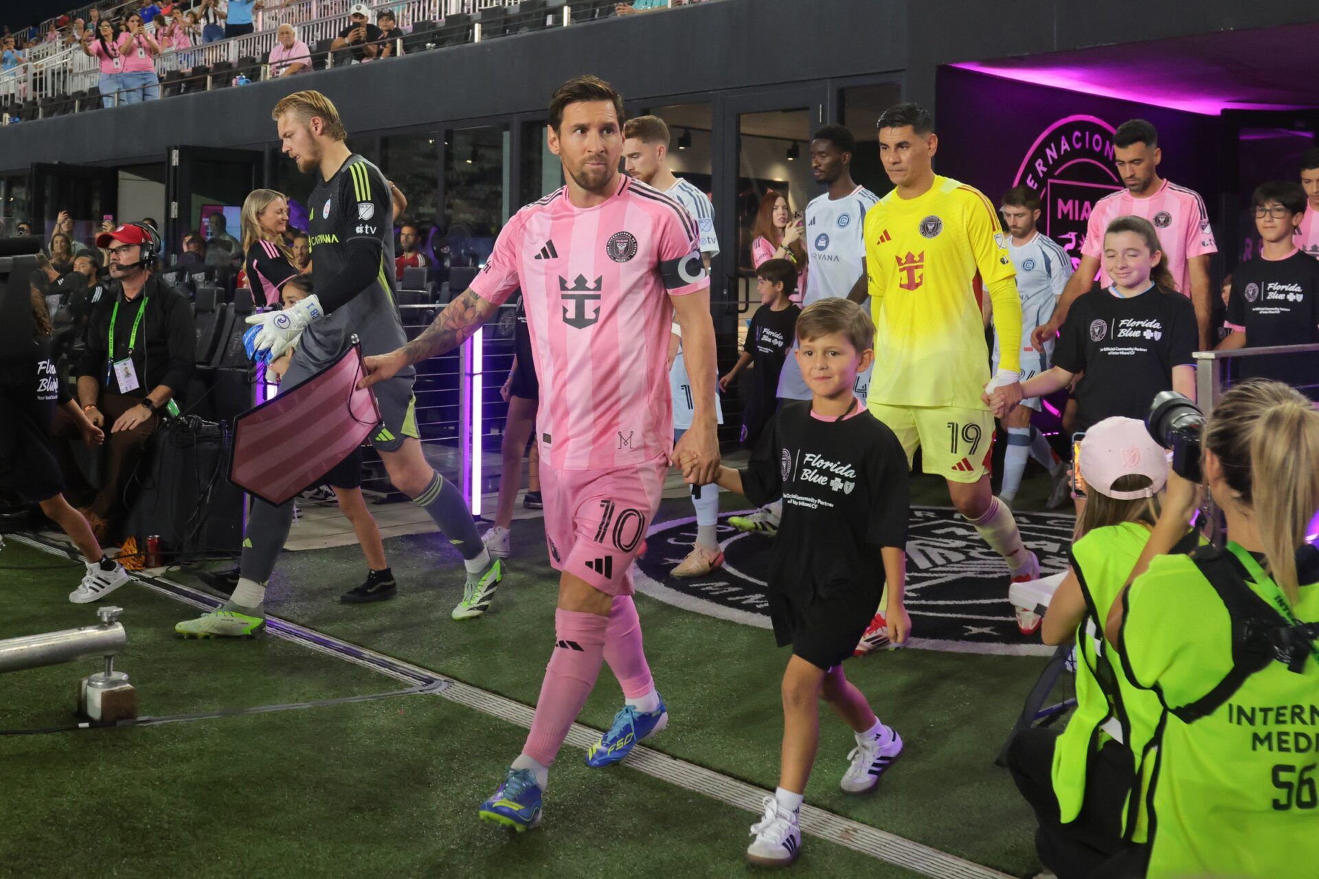 Inter Miami CF forward Lionel Messi (10) leads the team onto the field before the game against Chicago Fire at Chase Stadium.