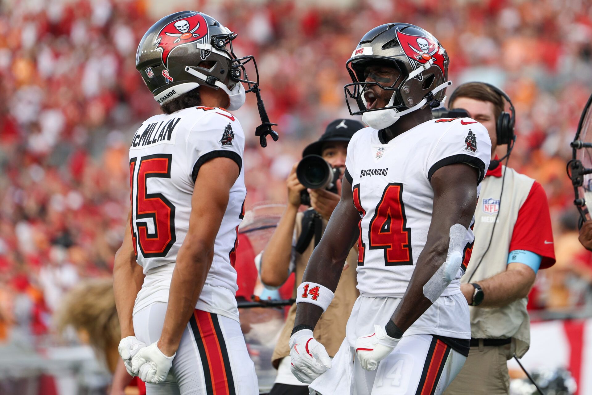 Tampa Bay Buccaneers wide receiver Jalen McMillan (15) and wide receiver Chris Godwin (14) celebrate a touchdown against the Washington Commanders in the third quarter  at Raymond James Stadium.