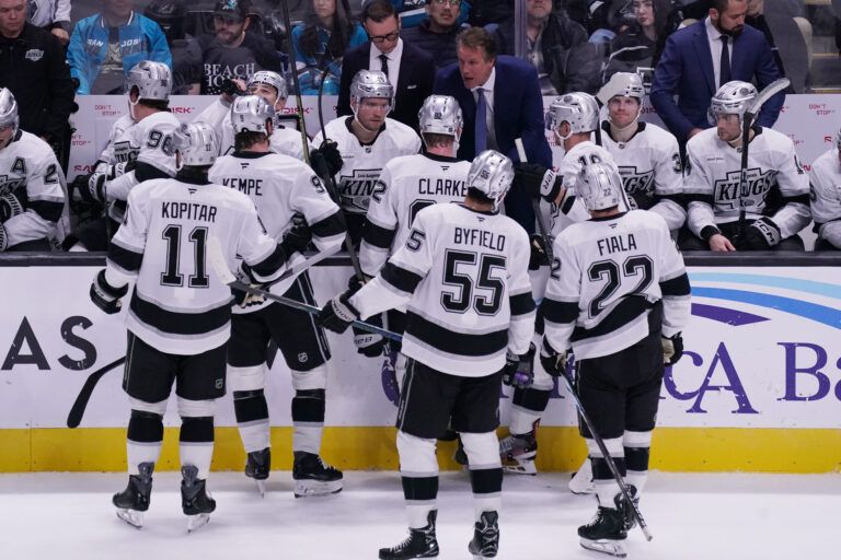 Los Angeles Kings head coach Jim Hiller talks with center Anze Kopitar (11), right winger Adrian Kempe (9), defenseman Brandt Clarke (92), right winger Quinton Byfield (55), left winger Kevin Fiala (22) and the team in the third period against the San Jose Sharks at SAP Center in San Jose.