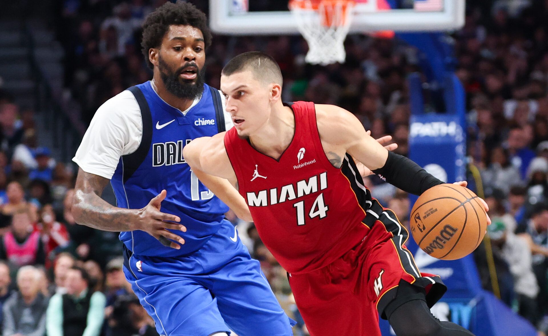 Miami Heat guard Tyler Herro (14) dribbles as Dallas Mavericks forward Naji Marshall (13) defends during the second half at American Airlines Center.