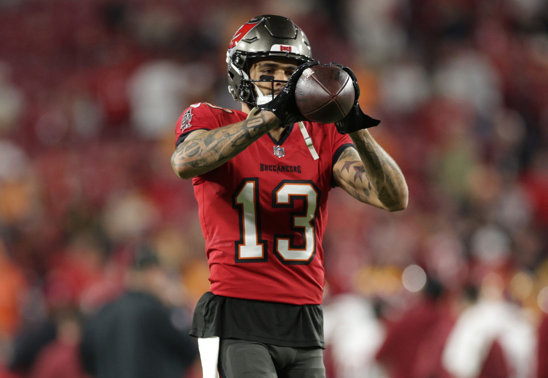 Tampa Bay Buccaneers wide receiver Mike Evans (13) warms up before a NFC wild card playoff against the Washington Commanders at Raymond James Stadium.