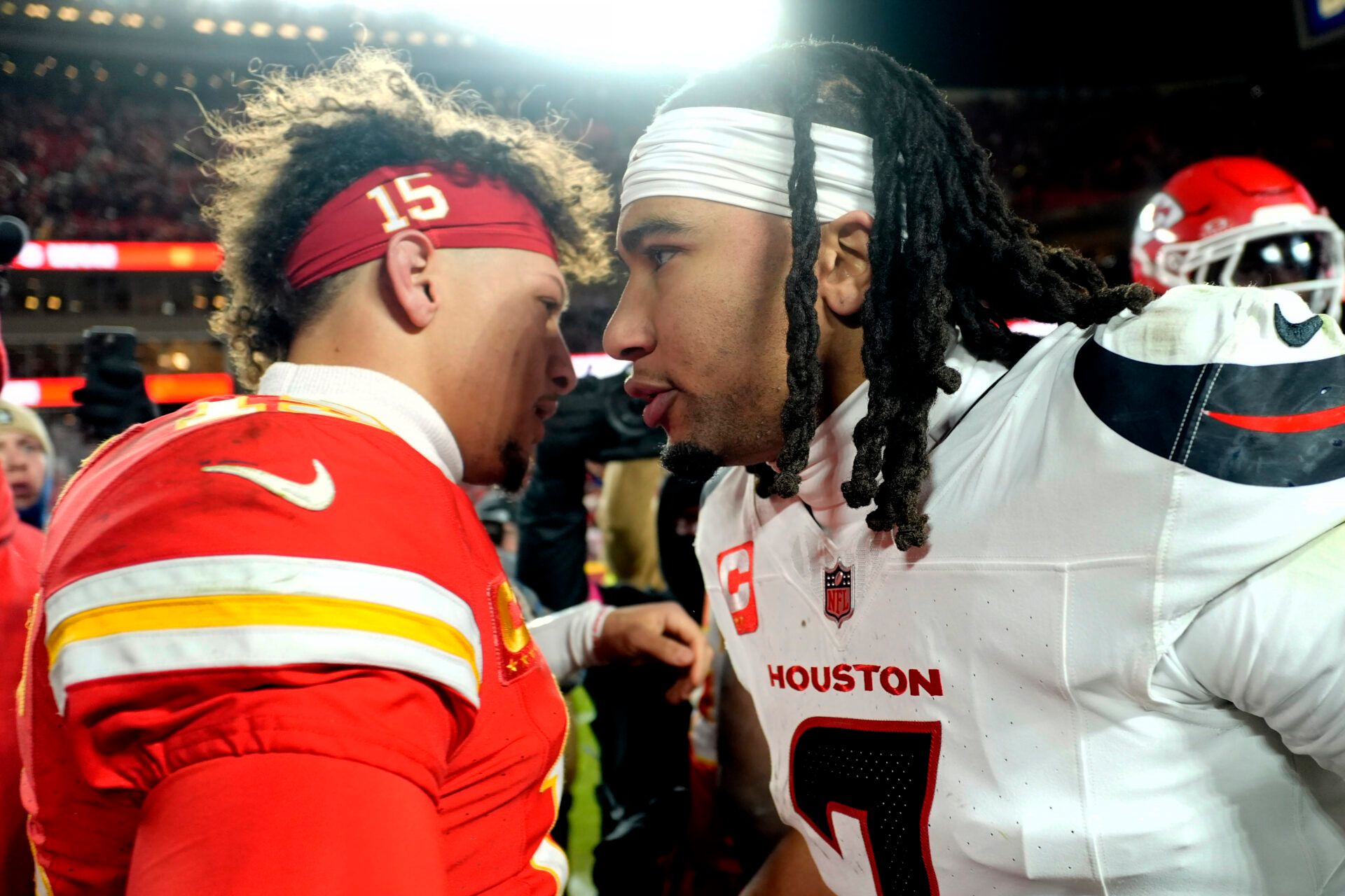 Kansas City Chiefs quarterback Patrick Mahomes (15) meets with Houston Texans quarterback C.J. Stroud (7) after a 2025 AFC divisional round game at GEHA Field at Arrowhead Stadium.