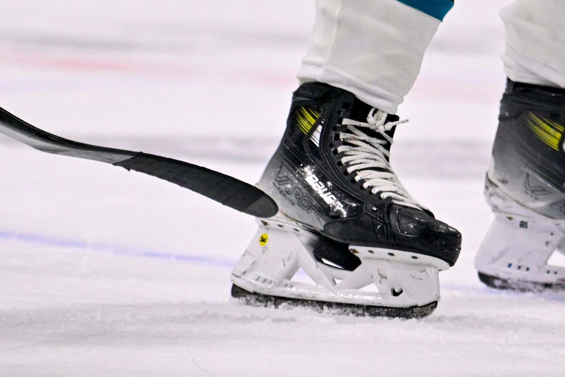 San Jose Sharks center Alexander Wennberg (21) checks his skate as a puck becomes lodged in the blade during the third period against the Dallas Stars at the American Airlines Center.