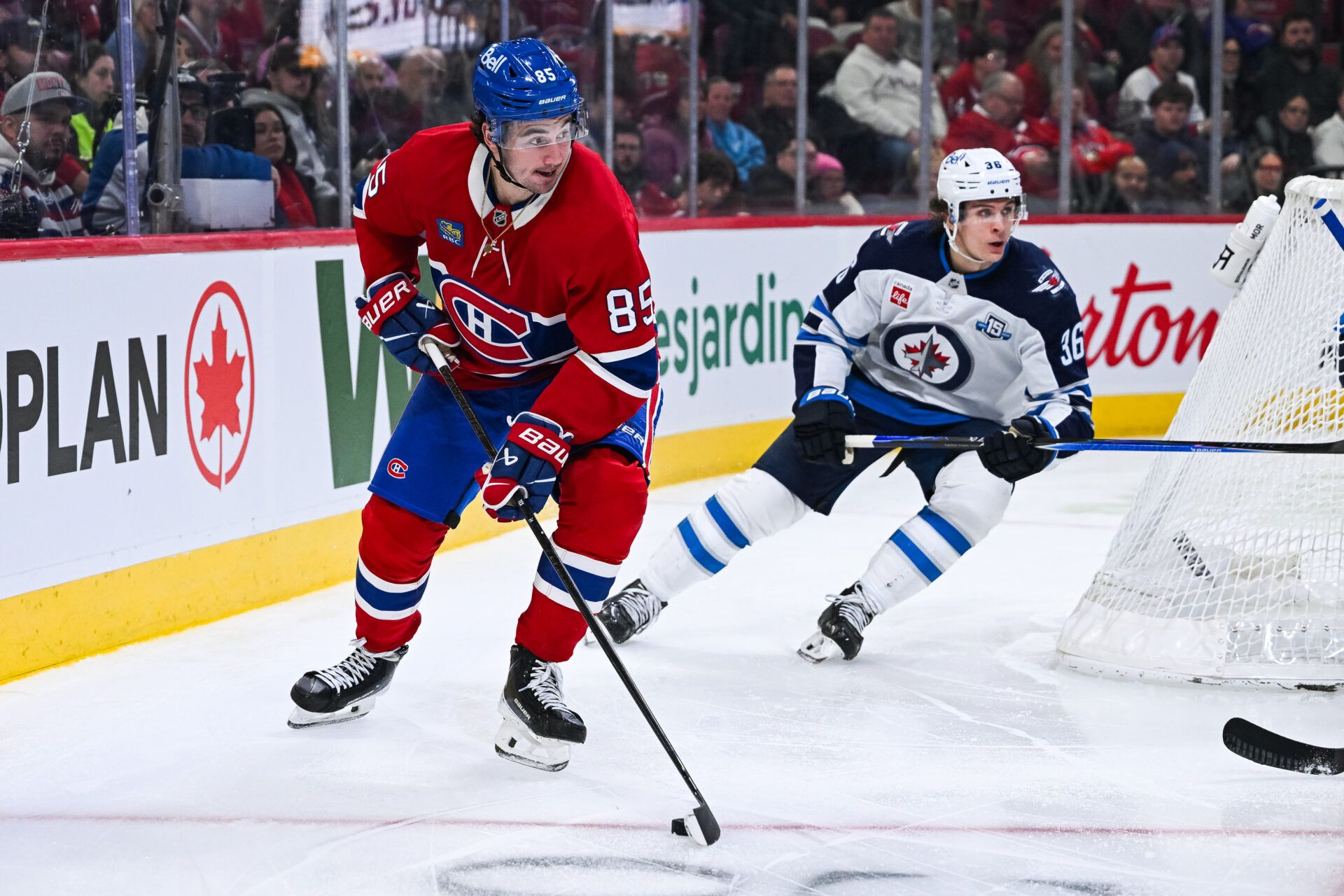 Montreal Canadiens left wing Alexandre Texier (85) plays the puck against Winnipeg Jets center Morgan Barron (36) during the third period at Bell Centre.
