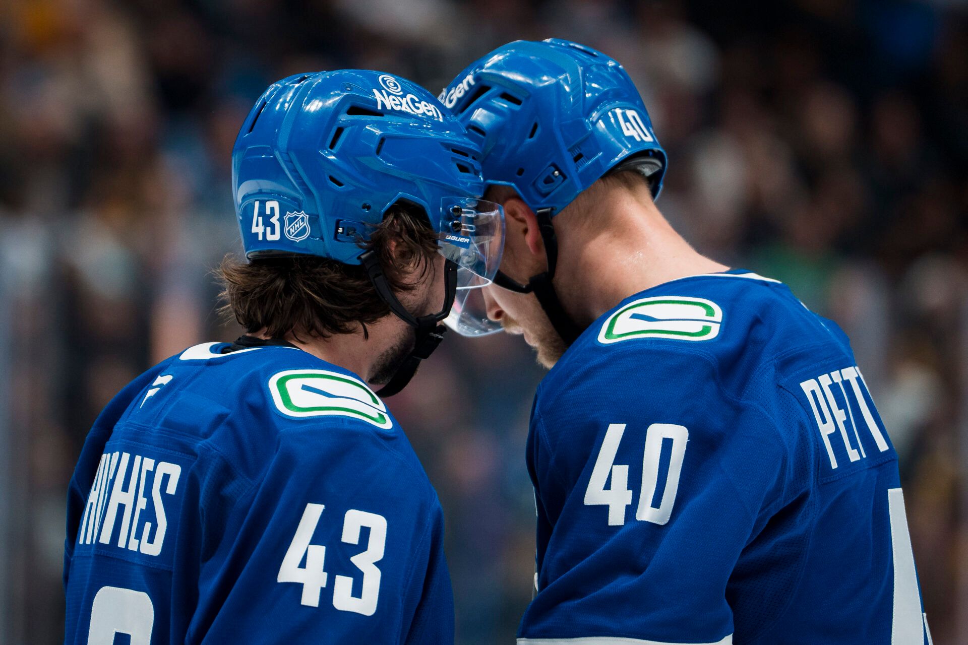 Vancouver Canucks defenseman Quinn Hughes (43) talks with forward Elias Pettersson (40) during a stop in play against the Chicago Blackhawks in the second period at Rogers Arena.