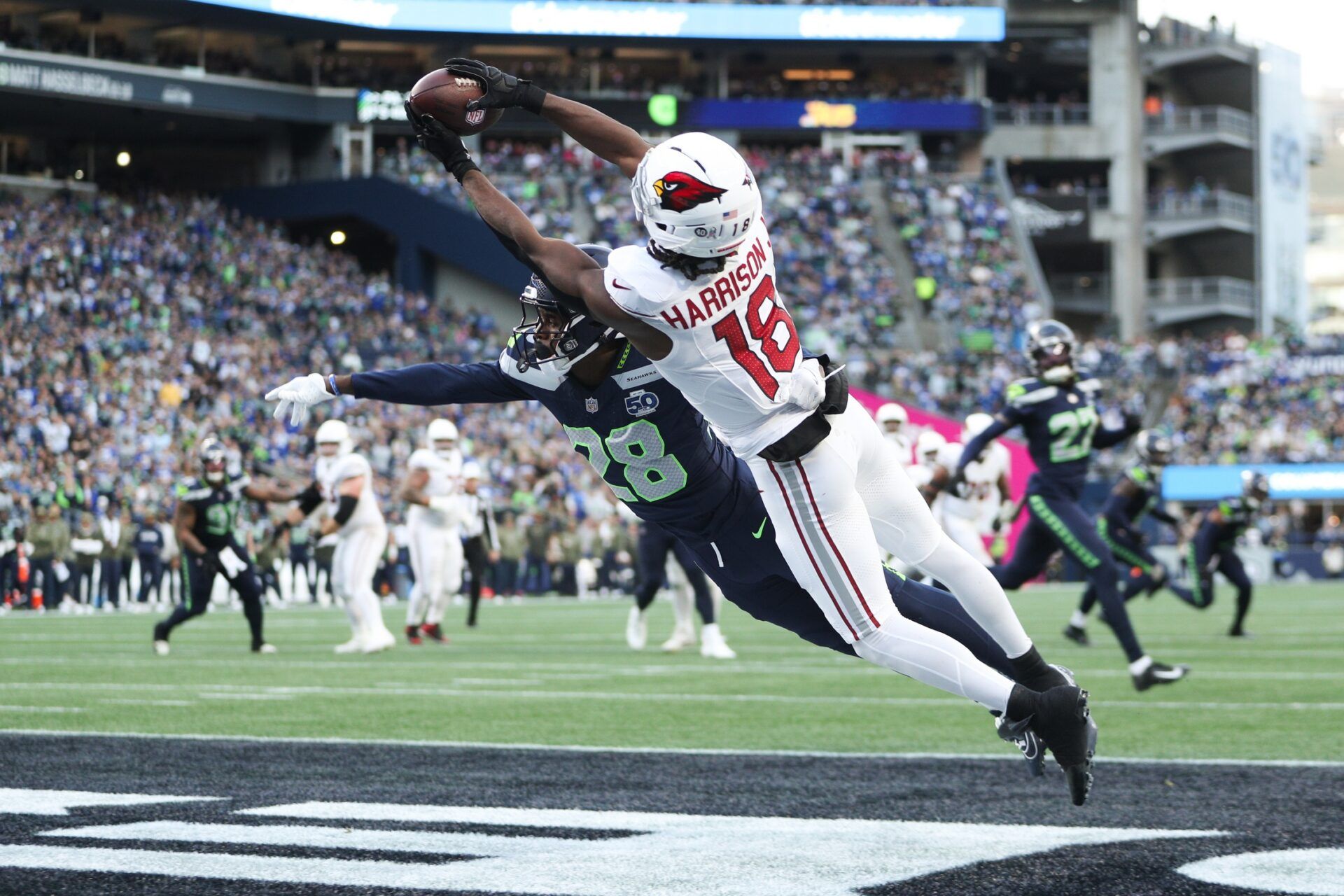 Seattle Seahawks cornerback Nehemiah Pritchett (28) breaks up a pass intended for Arizona Cardinals wide receiver Marvin Harrison Jr. (18) during the third quarter at Lumen Field.