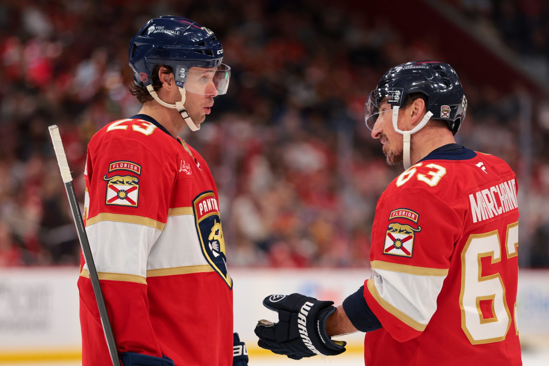 Florida Panthers center Carter Verhaeghe (23) and left wing Brad Marchand (63) speak against the Nashville Predators during the second period at Amerant Bank Arena.