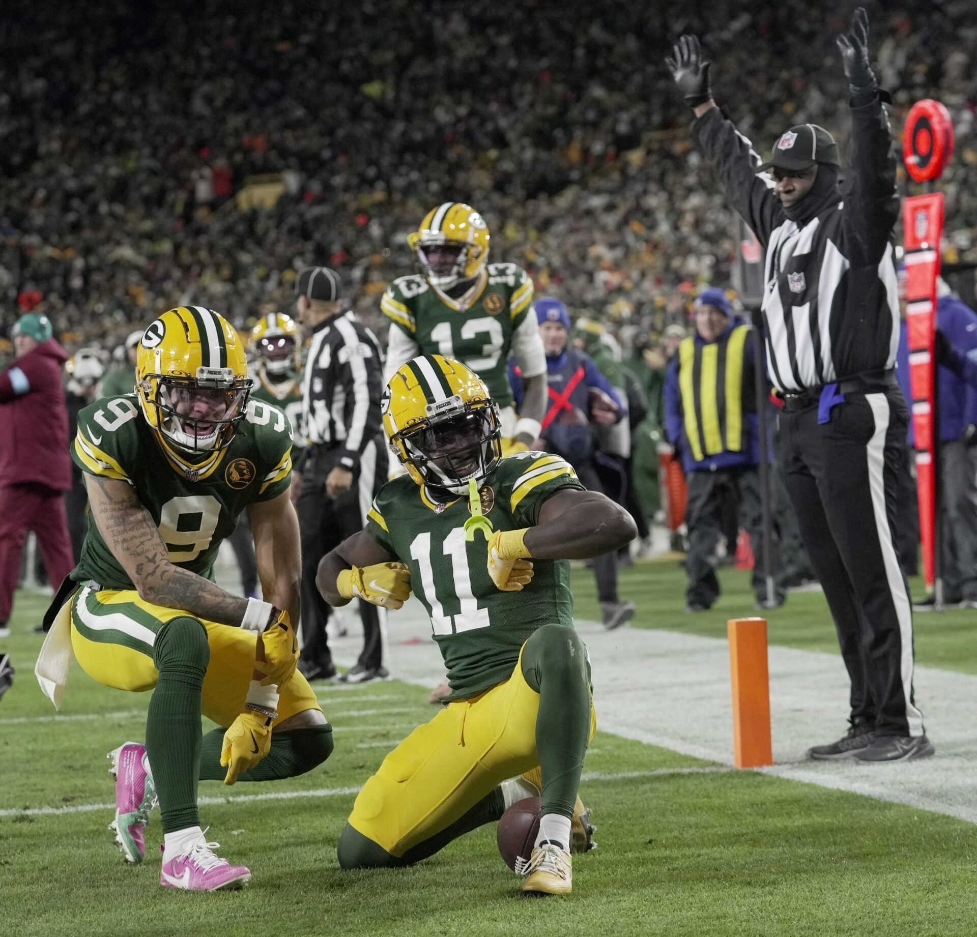 Green Bay Packers wide receiver Jayden Reed (11) celebrates his touchdown reception with wide receiver Christian Watson (9) during the second quarter at Lambeau Field.
