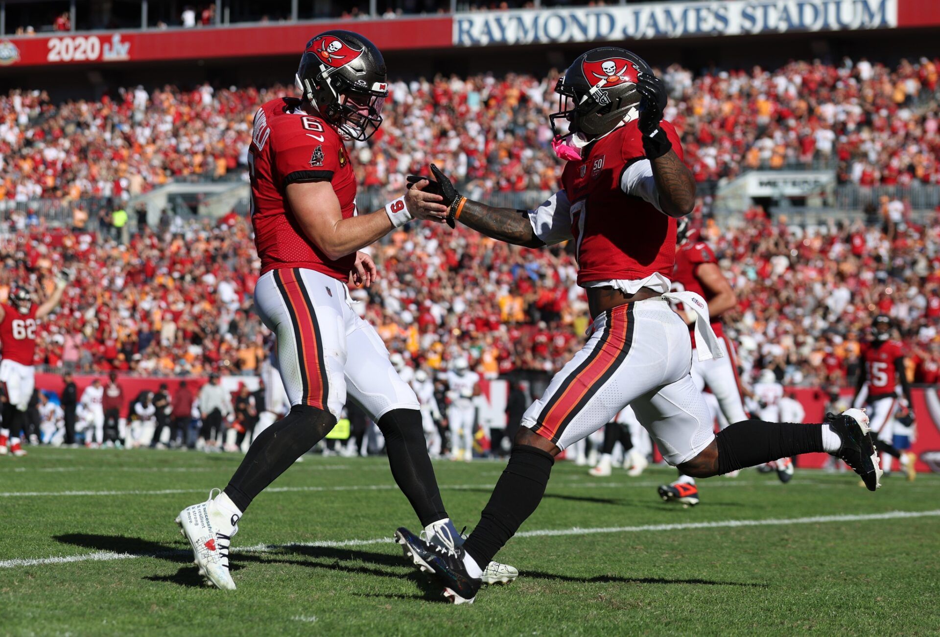 Tampa Bay Buccaneers running back Bucky Irving (7) celebrates with quarterback Baker Mayfield (6) after a touchdown during the second half against the Arizona Cardinals at Raymond James Stadium.