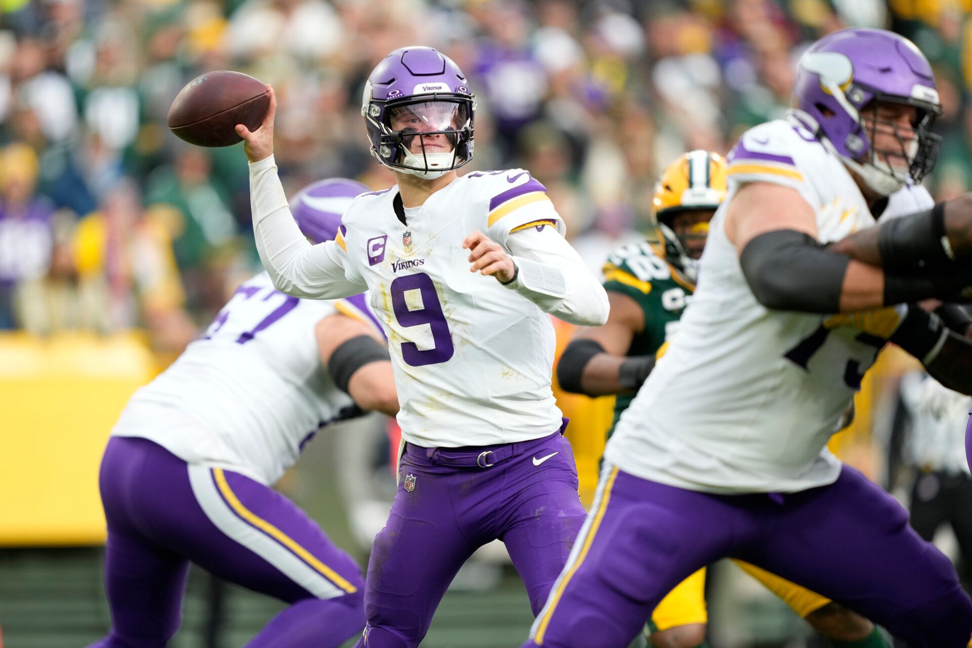 Minnesota Vikings quarterback J.J. McCarthy (9) throws the ball against the Green Bay Packers during the second half at Lambeau Field.