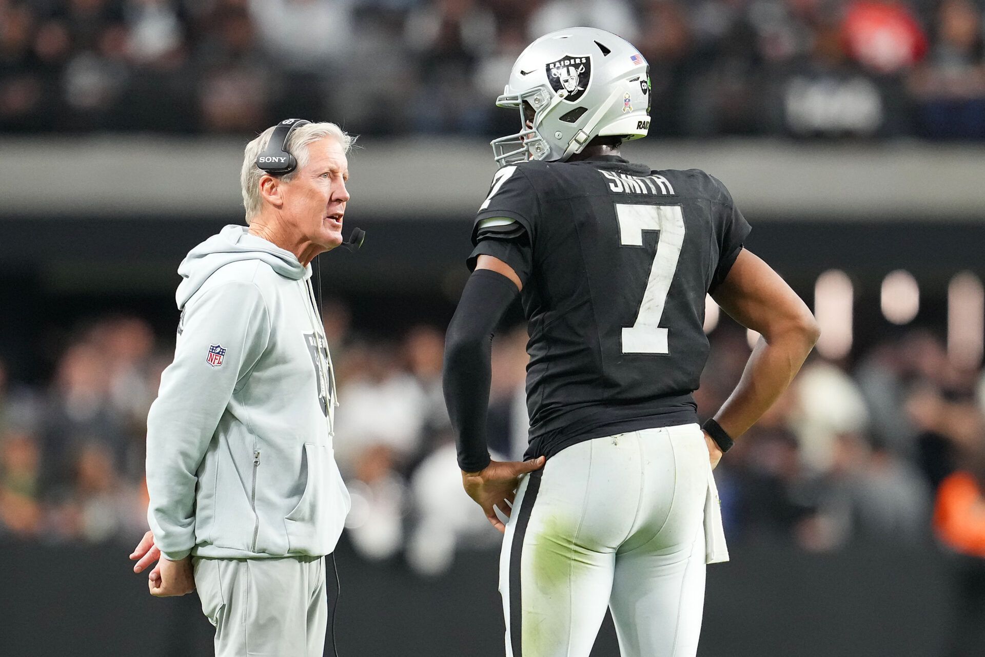 Las Vegas Raiders quarterback Geno Smith (7) talks to head coach Pete Carroll in game against the Cleveland Browns during the fourth quarter at Allegiant Stadium.
