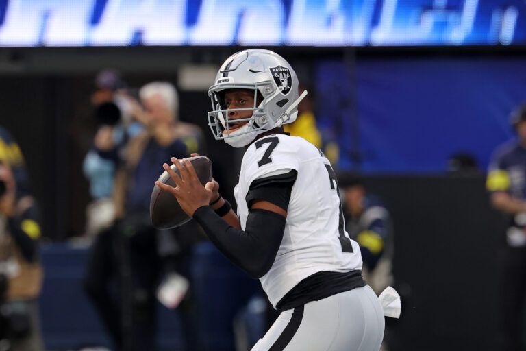Las Vegas Raiders quarterback Geno Smith (7) drops back to pass against the Los Angeles Chargers during the first half at SoFi Stadium.