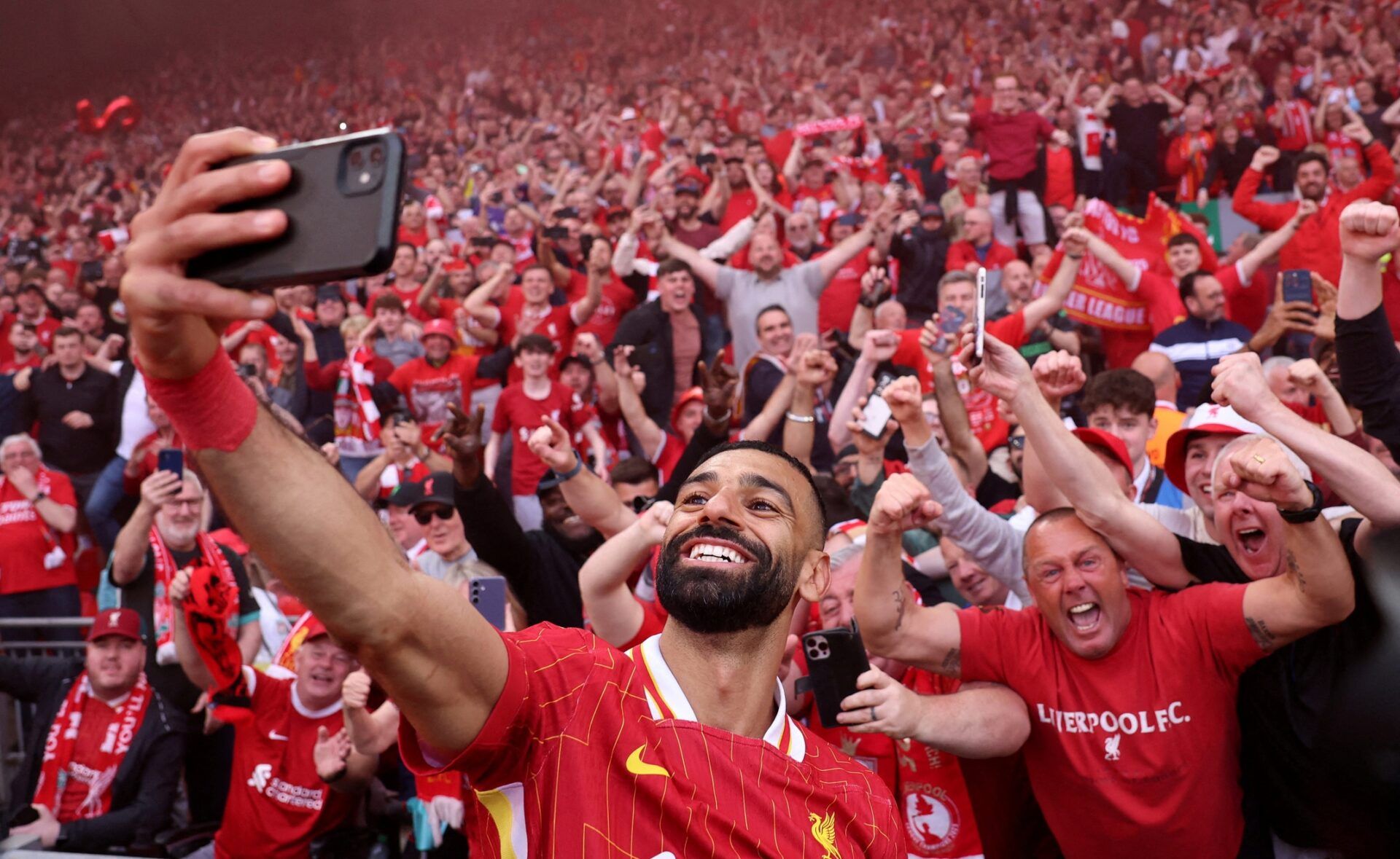 [US, Mexico & Canada customers only] April 27, 2025; Anfield, Liverpool, BRITAIN; Liverpool player Mohamed Salah celebrates by taking a selfie after winning the Premier League.