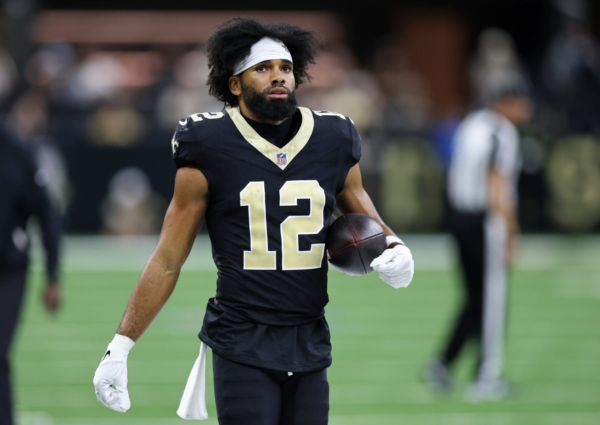 New Orleans Saints wide receiver Chris Olave (12) walks on the sideline during the second half at Caesars Superdome.