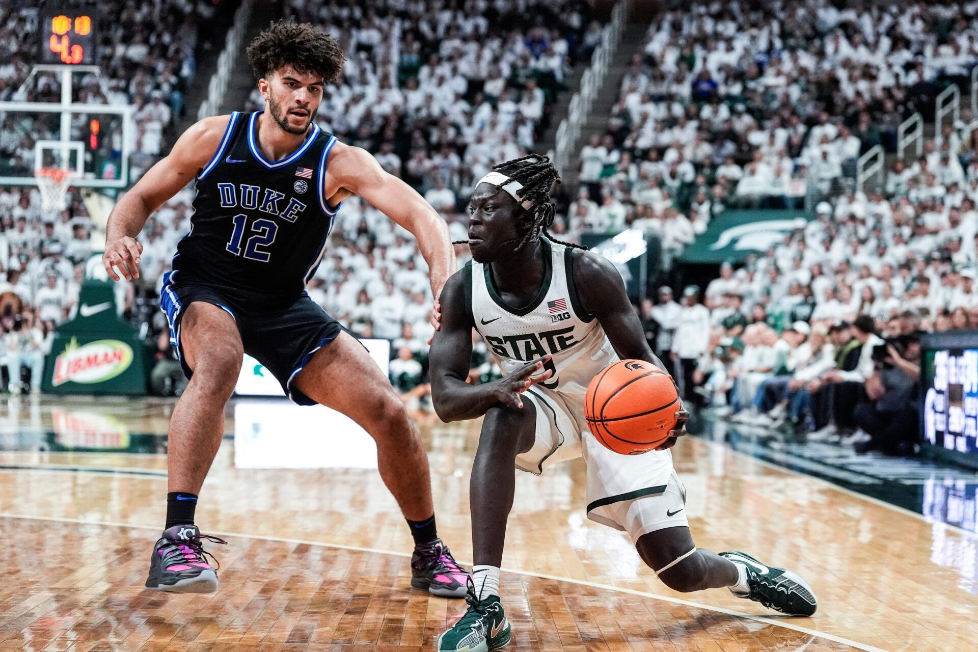 Michigan State guard Kur Teng (2) dribbles against Duke forward Cameron Boozer (12) during the second half at Breslin Center in East Lansing on Saturday, Dec. 6, 2025.