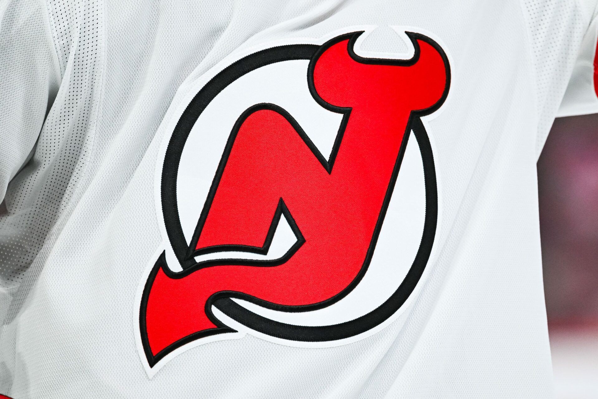 View of a New Jersey Devils logo on a jersey worn by a member of the team during the second period at Bell Centre.