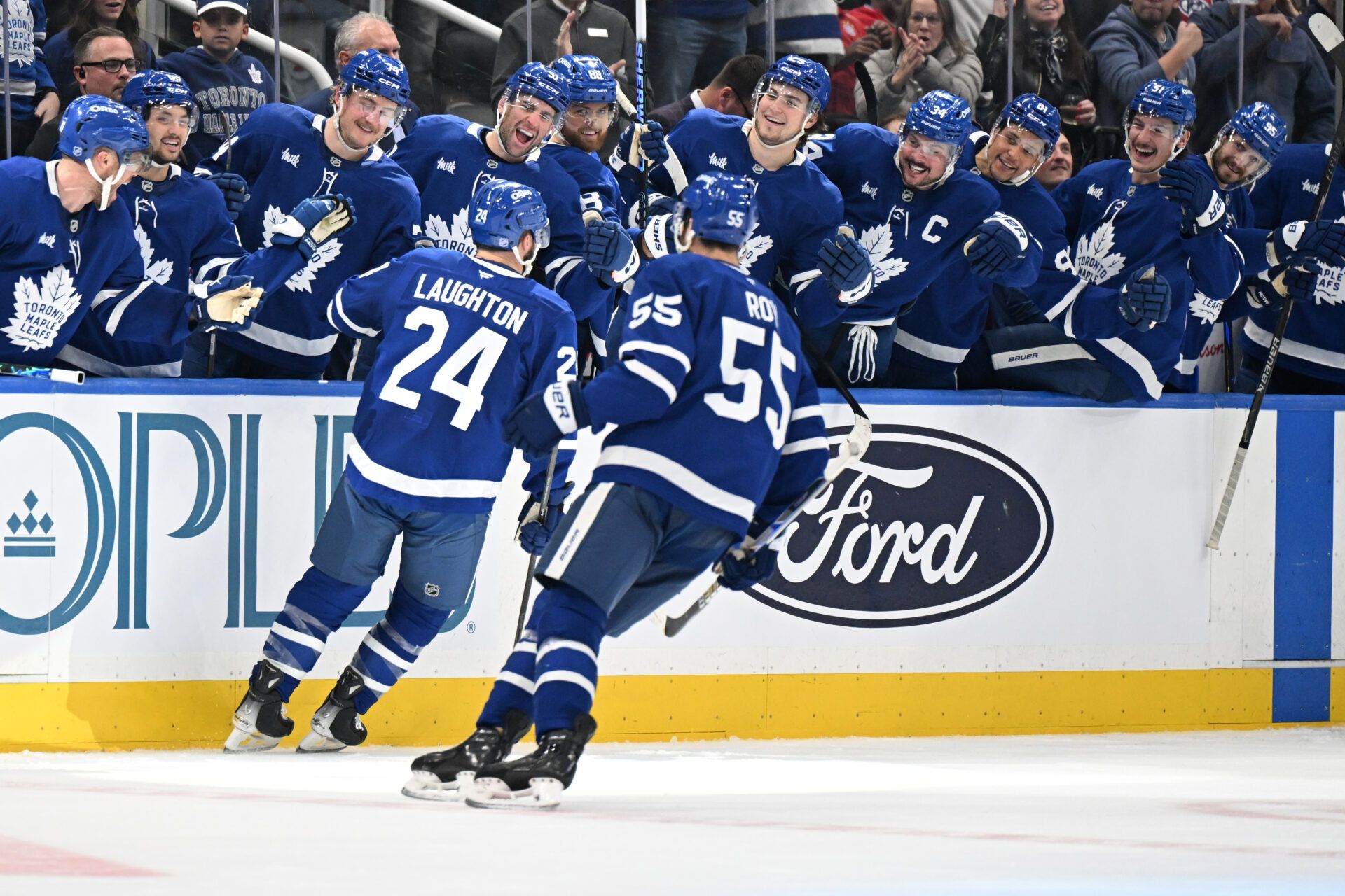 Toronto Maple Leafs forward Scott Laughton (24) celebrates with team mates at the bench after scoring a goal against the Montreal Canadiens in the third period at Scotiabank Arena.