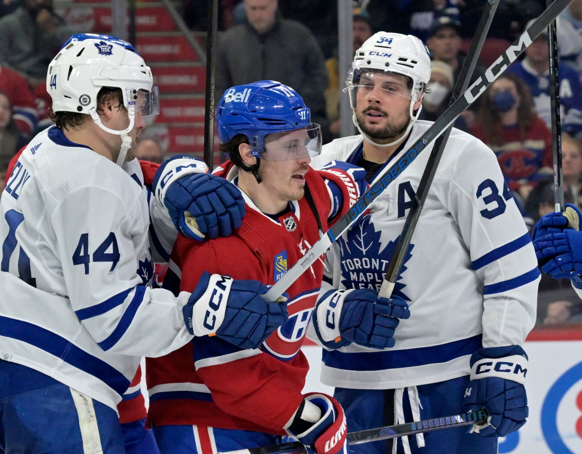 Toronto Maple Leafs defenseman Morgan Rielly (44) and teammate Toronto Maple Leafs forward Auston Matthews (34) escort Montreal Canadiens forward Brendan Gallagher (11) away from their net during the second period at the Bell Centre.