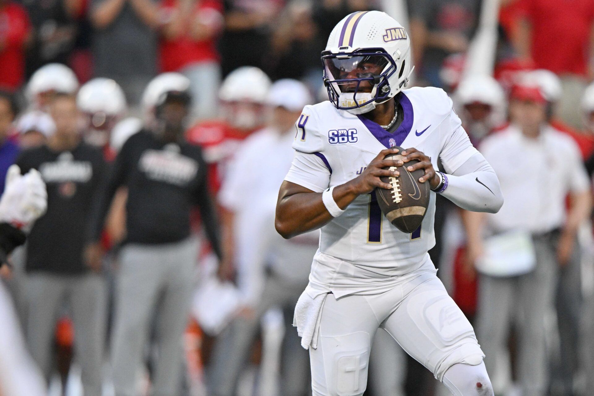 James Madison Dukes quarterback Alonza Barnett III (14) looks to pass against the Louisville Cardinals during the first half at L&N Federal Credit Union Stadium. Louisville defeated James Madison 28-14.