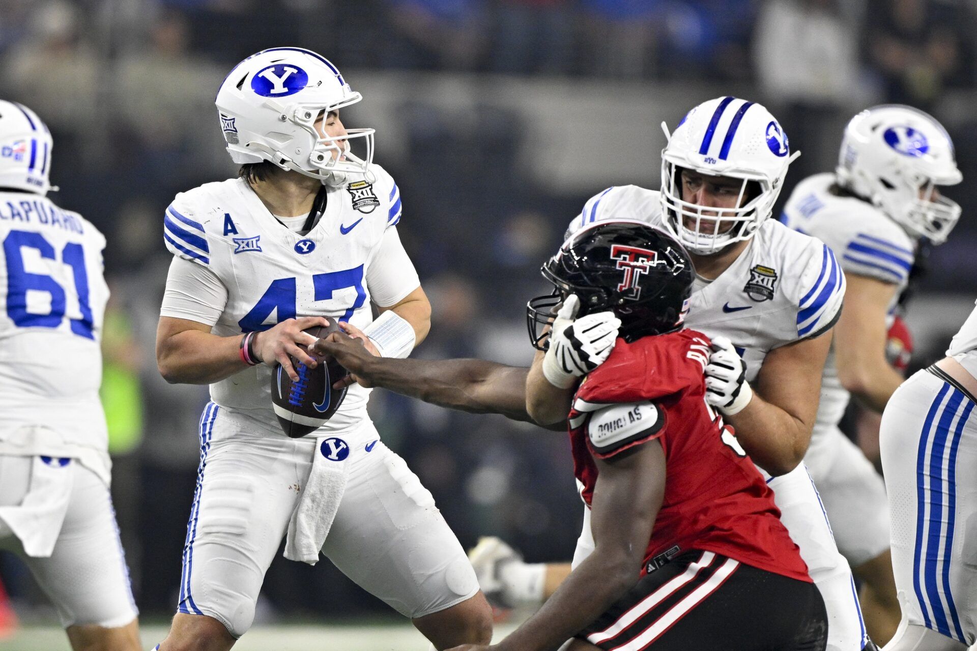 Texas Tech Red Raiders defensive back Miquel Dingle Jr. (21) strips the ball away from BYU Cougars quarterback Bear Bachmeier (47) during the second half at AT&T Stadium.