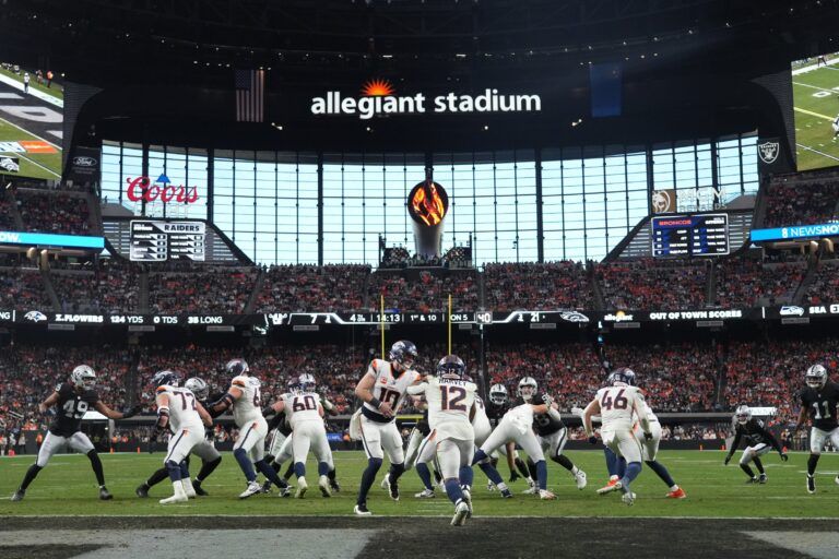 Denver Broncos running back RJ Harvey (12) takes the handoff from quarterback Bo Nix (10) against the Las Vegas Raiders during the second half at Allegiant Stadium.