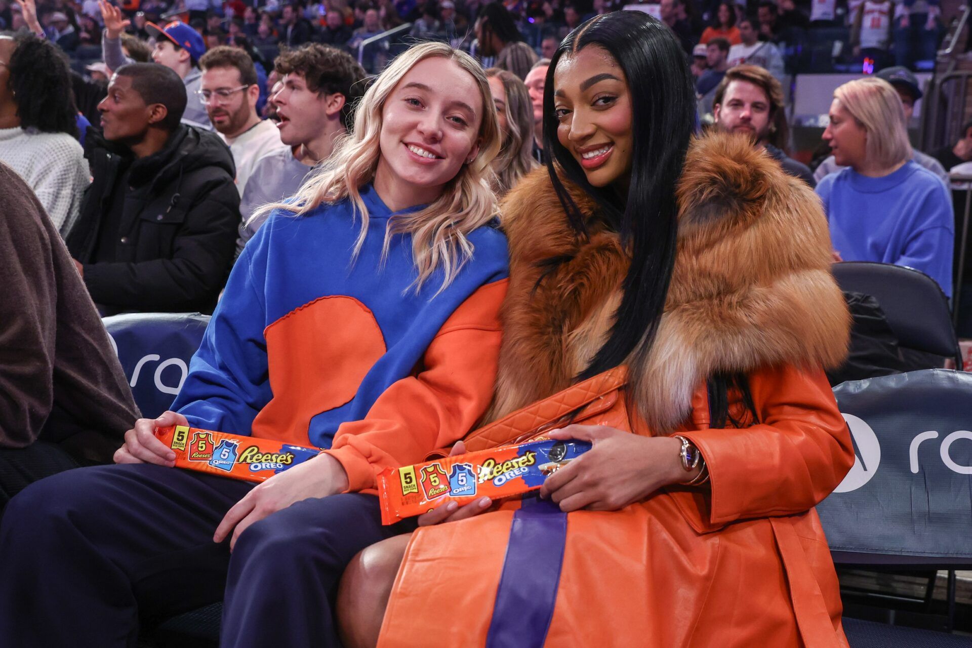 WNBA players Paige Bueckers (l) and Angel Reese (r) sit courtside during the game between the Orlando Magic and the New York Knicks at Madison Square Garden.
