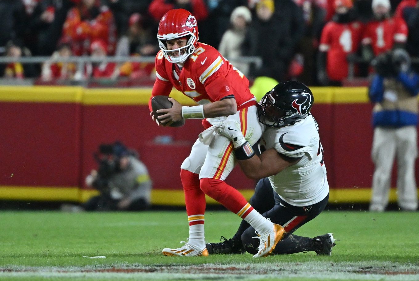 Kansas City Chiefs quarterback Patrick Mahomes (15) is sacked by Houston Texans defensive tackle Tommy Togiai (72) during the first quarter at GEHA Field at Arrowhead Stadium.