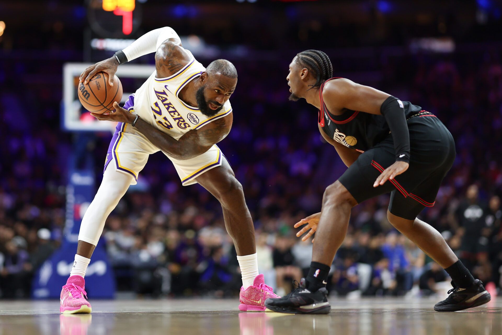 Los Angeles Lakers forward Lebron James (23) controls the ball against Philadelphia 76ers guard Tyrese Maxey during the first quarter at Xfinity Mobile Arena.