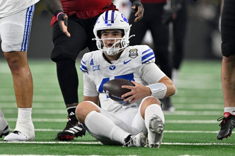 BYU Cougars quarterback Bear Bachmeier (47) sits on the field after recovering the loose ball during the first half against the Texas Tech Red Raiders at AT&T Stadium.