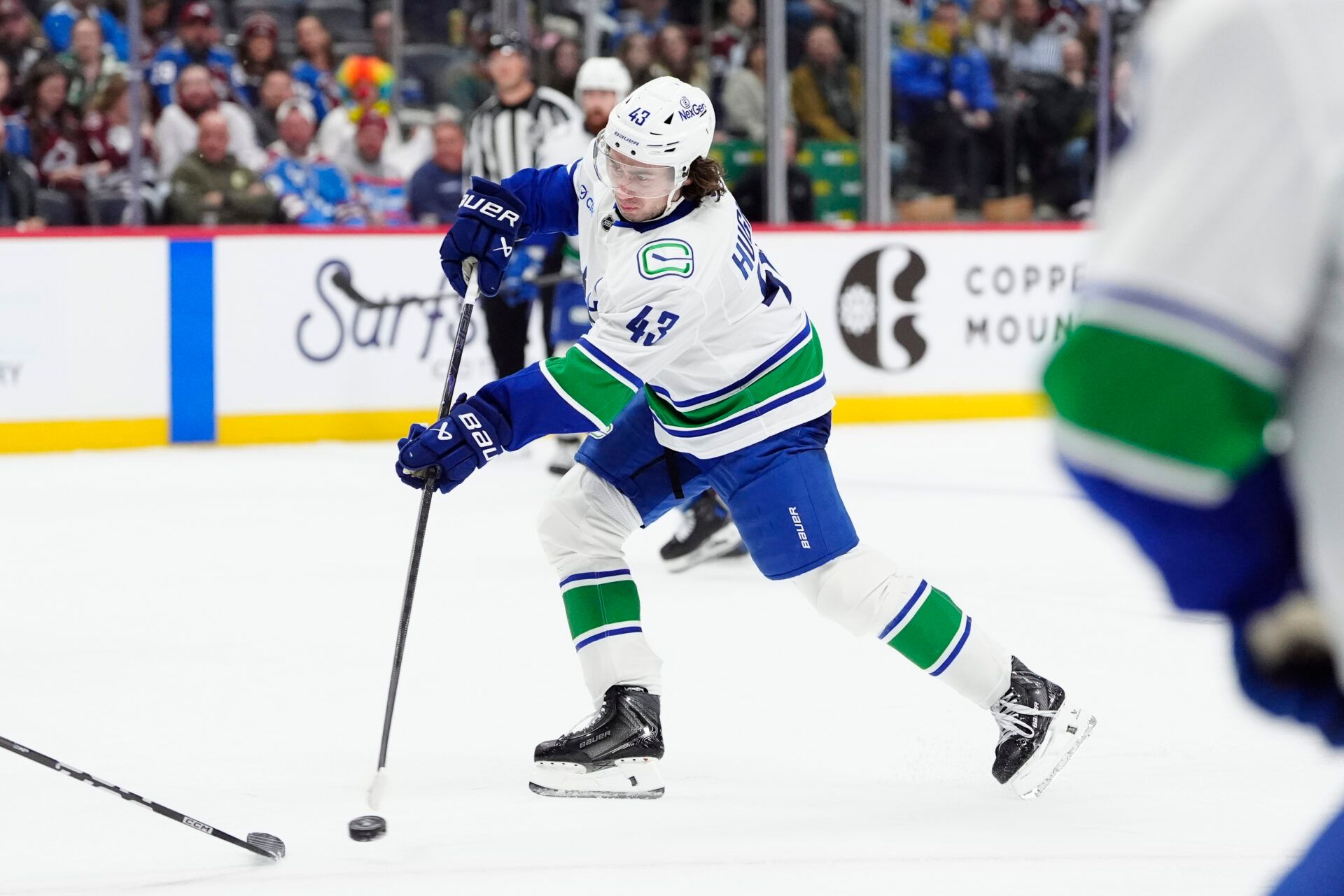 Vancouver Canucks defenseman Quinn Hughes (43) takes a shot on goal in the third period against the Colorado Avalanche at Ball Arena.