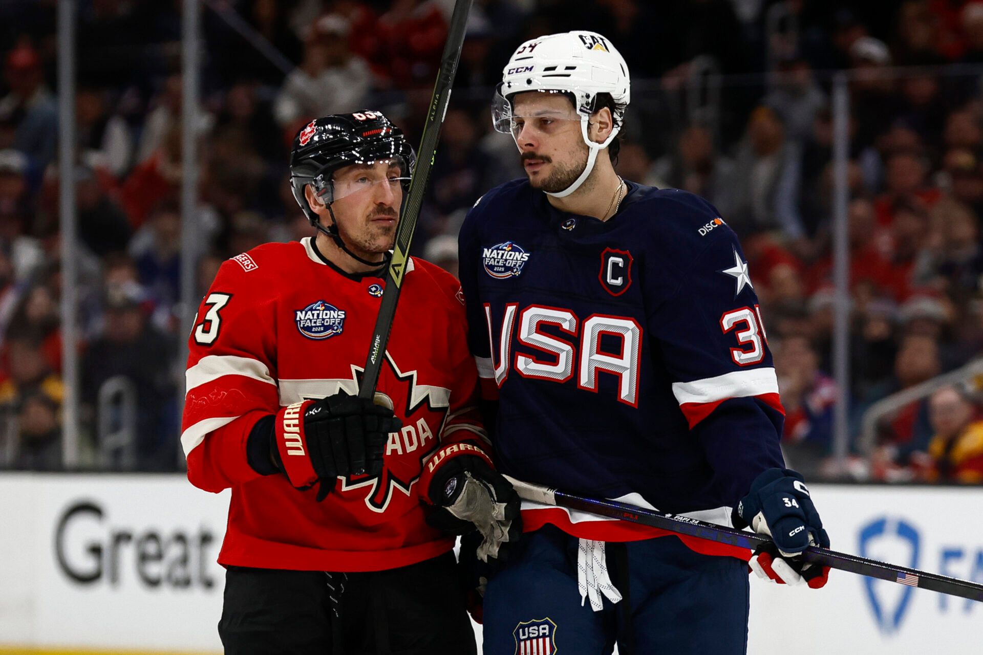 [Imagn Images direct customers only] Team Canada forward Brad Marchand (63) and United States forward Auston Matthews (34) during the 4 Nations Face-Off ice hockey championship game at TD Garden.