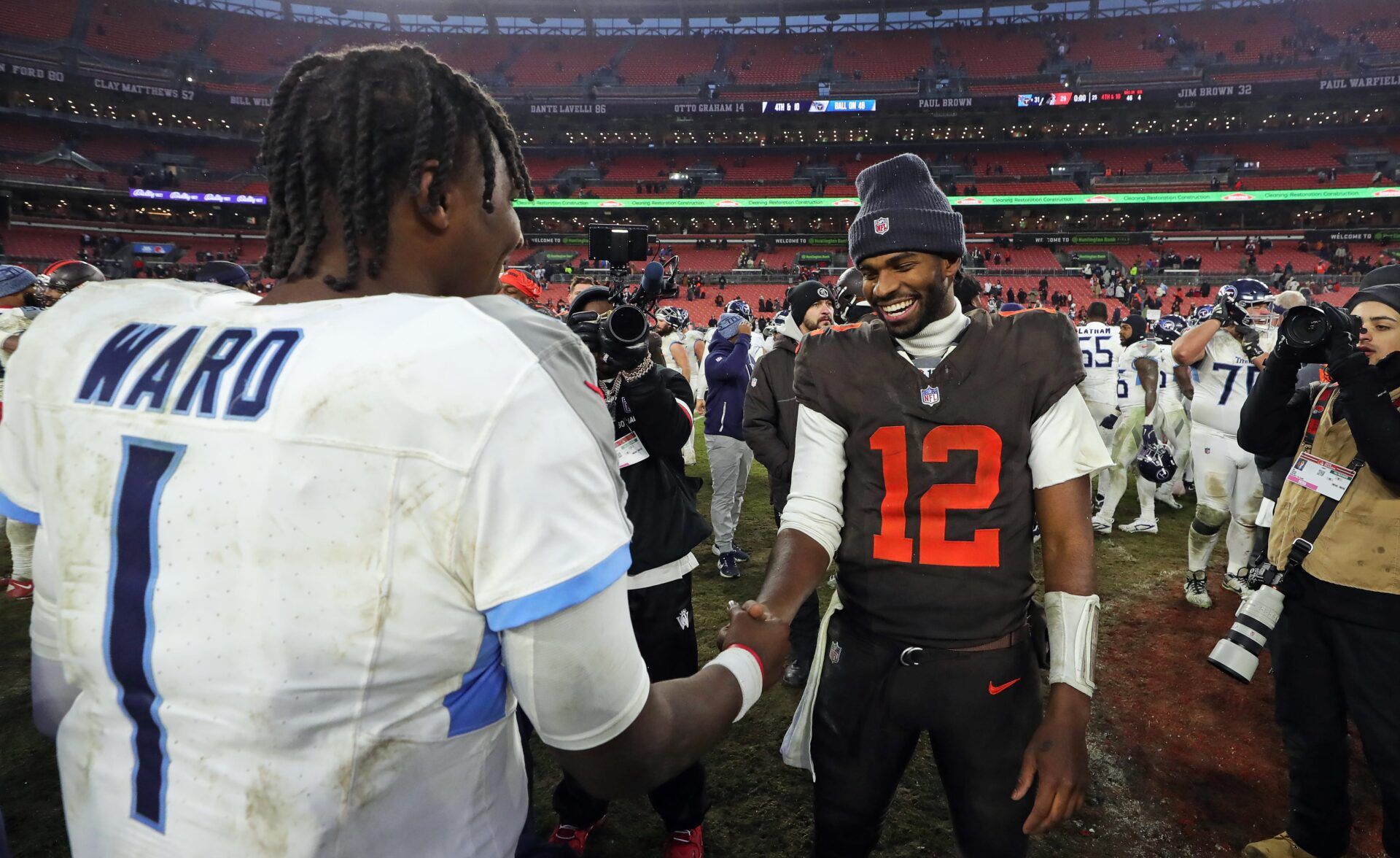 Cleveland Browns quarterback Shedeur Sanders (12) shakes hands with Tennessee Titans quarterback Cam Ward (1) after the Titans beat the Browns on Dec. 7, 2025, in Cleveland.