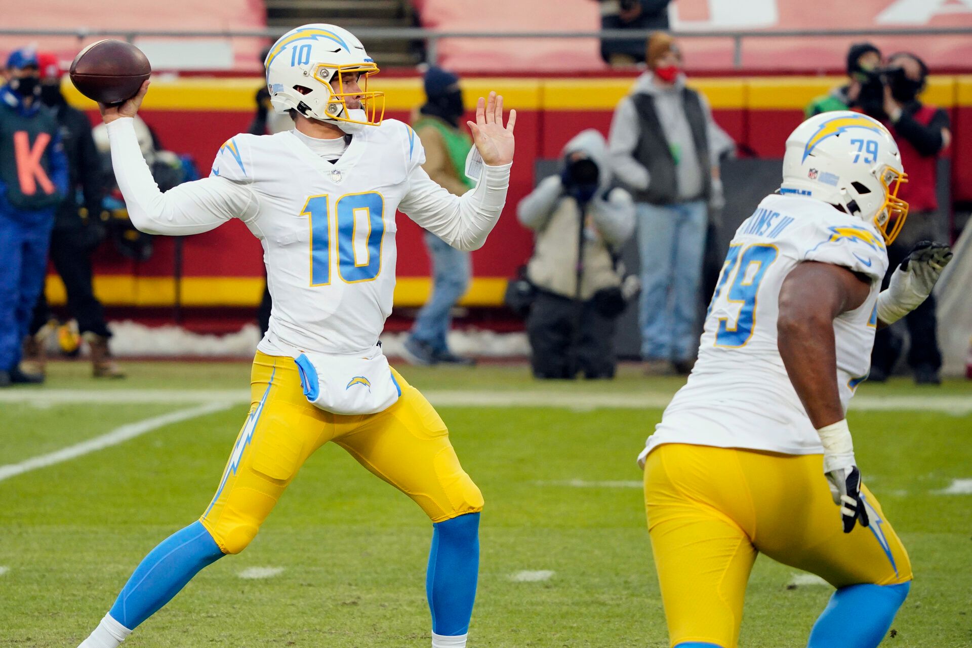 Los Angeles Chargers quarterback Justin Herbert (10) throws a pass against the Kansas City Chiefs as Chargers offensive tackle Trey Pipkins (79) blocks during the first half at Arrowhead Stadium.