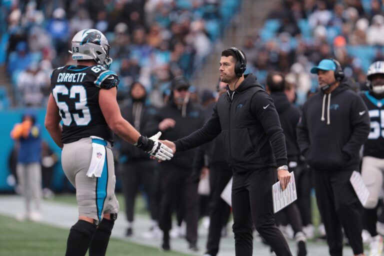 Carolina Panthers head coach Dave Canales greets Carolina Panthers center Austin Corbett (63) during the second quarter against the Los Angeles Rams at Bank of America Stadium.