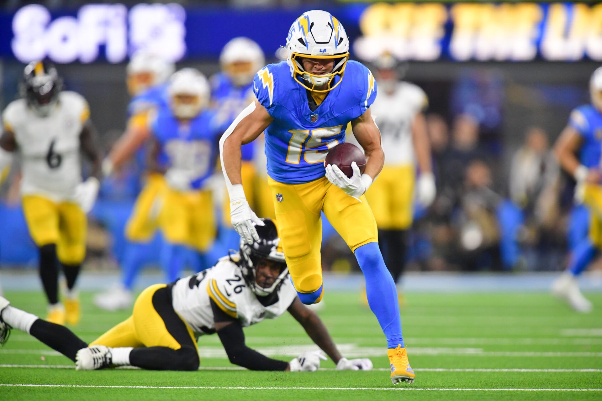 Los Angeles Chargers wide receiver Ladd McConkey (15) carries the ball after a reception against the Pittsburgh Steelers during the fourth quarter of the game at SoFi Stadium.