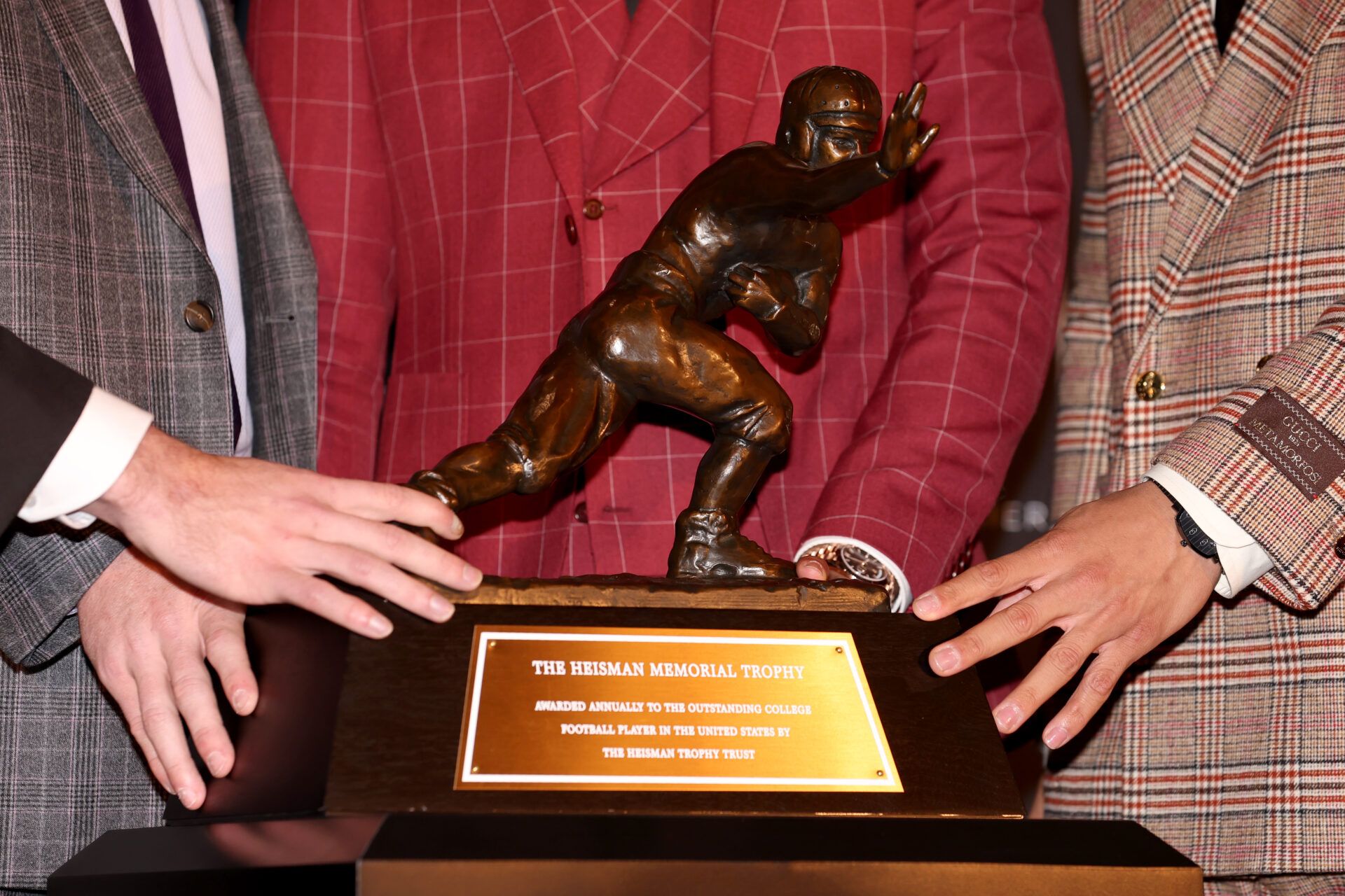 Heisman Trophy finalists (left to right) Georgia quarterback Stetson Bennett and TCU quarterback Max Duggan and Ohio State quarterback C.J. Stroud and Southern California quarterback Caleb Williams touch the trophy during a press conference in the Astor Ballroom at the New York Marriott Marquis in New York, NY, before the 2022 Heisman Trophy award ceremony.