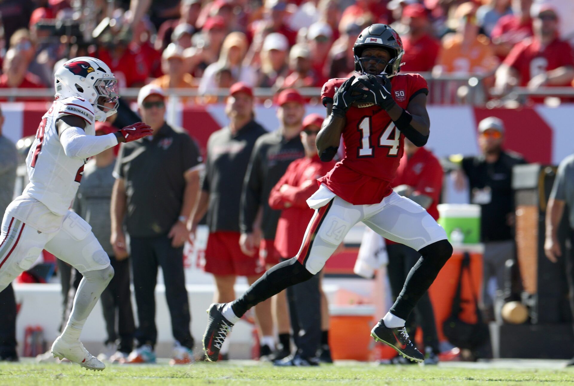 Tampa Bay Buccaneers wide receiver Chris Godwin Jr. (14) makes a catch against Arizona Cardinals cornerback Garrett Williams (21) during the first half at Raymond James Stadium.