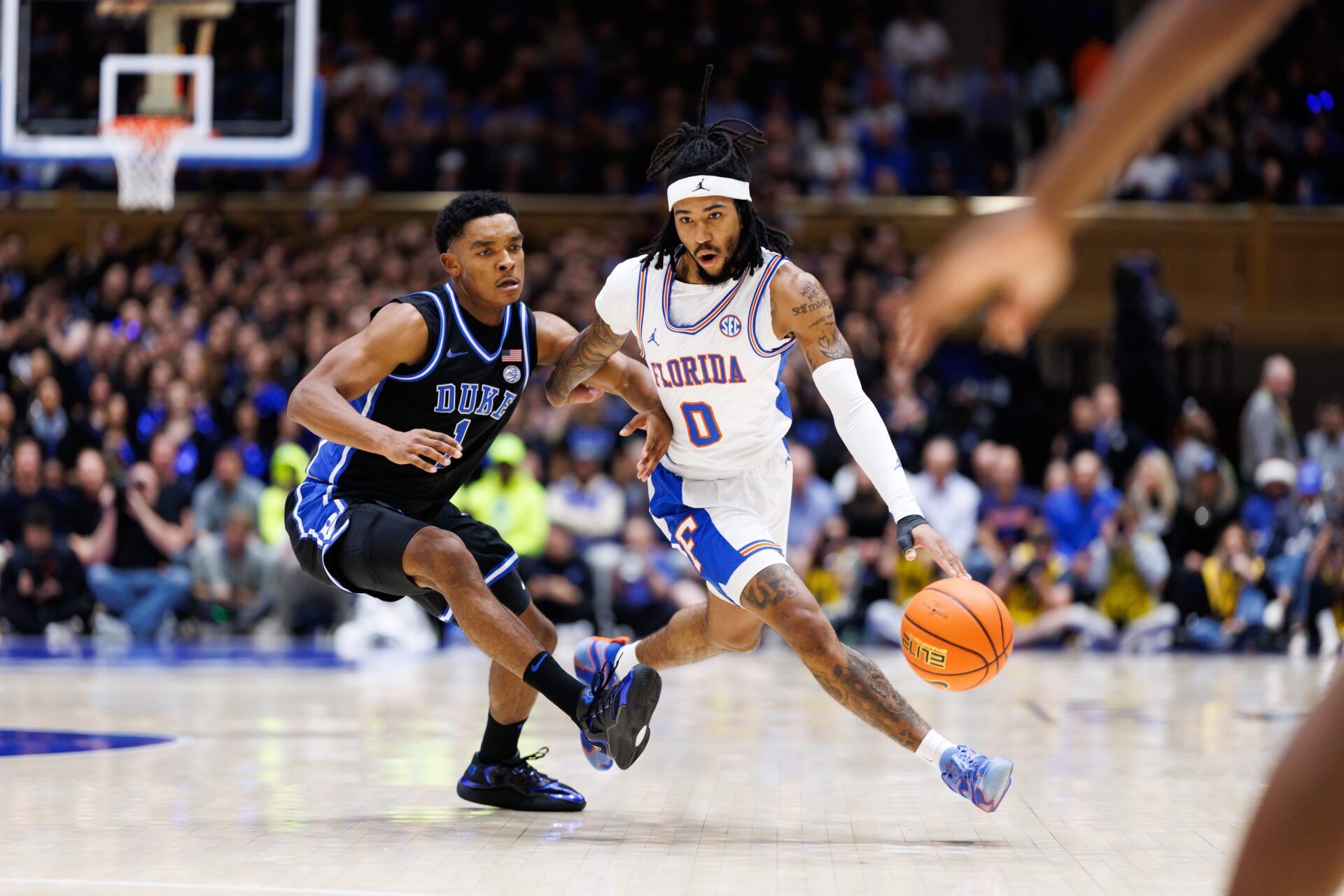 Florida Gators guard Boogie Fland (0) drives to the basket past Duke Blue Devils guard Caleb Foster (1) during the first half at Cameron Indoor Stadium in Durham, NC on Tuesday, December 2, 2025. [Matt Pendleton/Gainesville Sun]