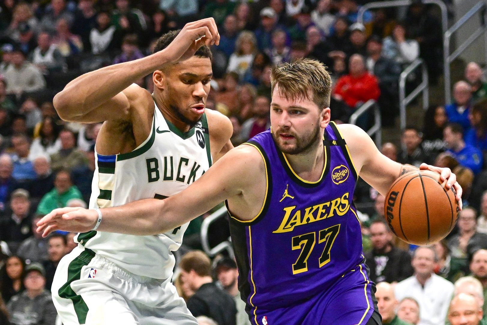 Los Angeles Lakers guard Luka Doncic (77) drives to the basket against Milwaukee Bucks forward Giannis Antetokounmpo (34) in the third quarter at Fiserv Forum.