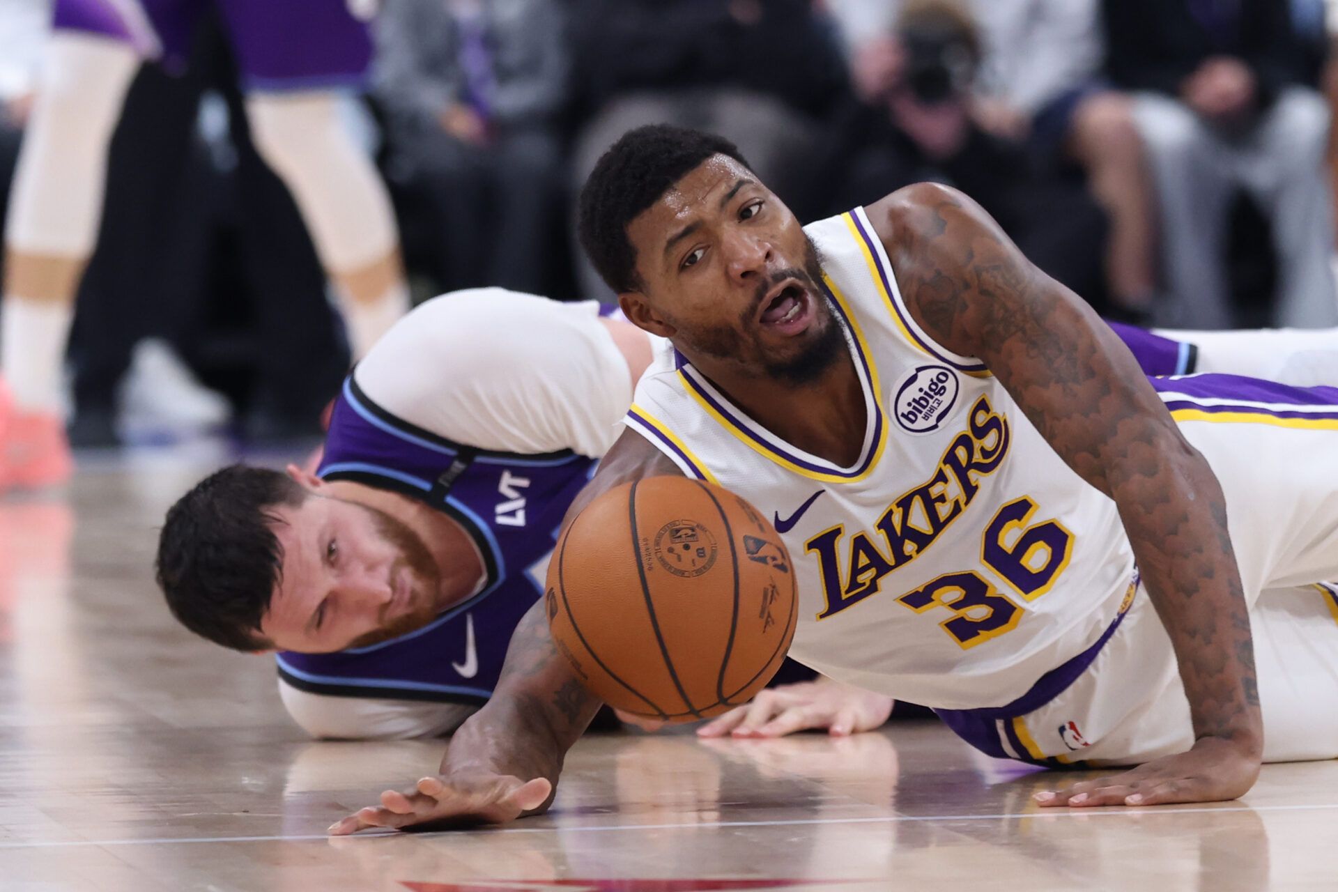 Los Angeles Lakers guard Marcus Smart (36) and Utah Jazz center Jusuf Nurkic (30) goes for a loose ball during the second quarter at Delta Center.