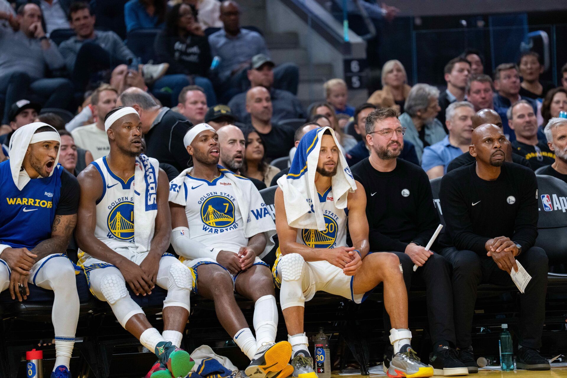 Golden State Warriors guard Stephen Curry (30) on the bench with  forward Jimmy Butler III (10) and guard Buddy Hield (7) and guard Gary Payton II (0) during the game against the LA Clippers during the fourth quarter at Chase Center.