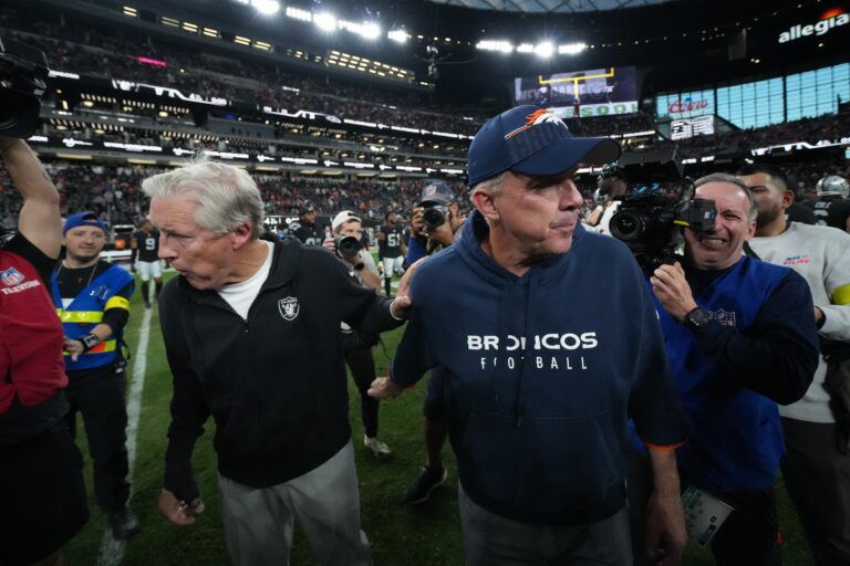 Las Vegas Raiders head coach Pete Carroll and Denver Broncos head coach Sean Payton meet on the field following a game at Allegiant Stadium.