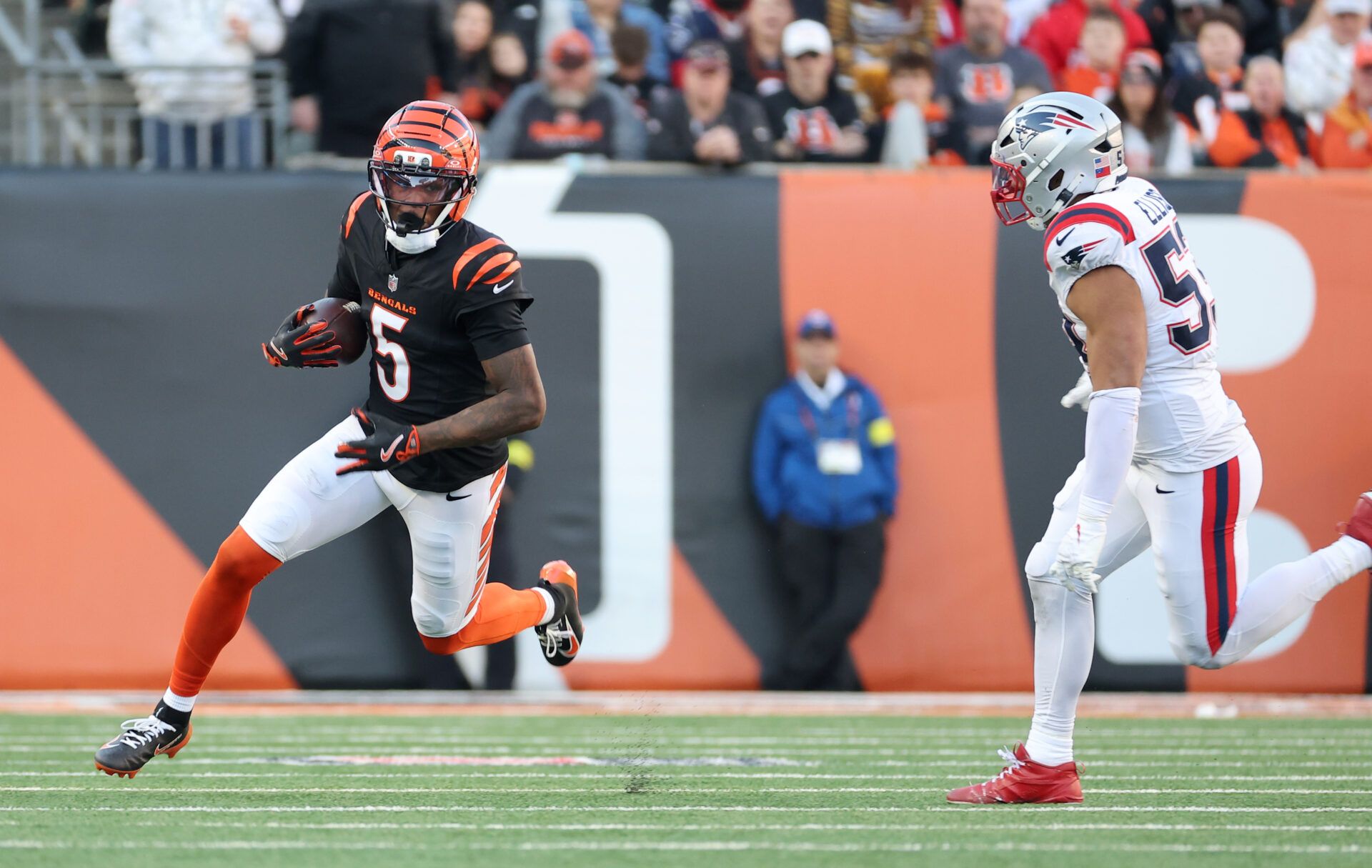 Cincinnati Bengals wide receiver Tee Higgins (5) runs against New England Patriots linebacker Christian Elliss (53) during the second half at Paycor Stadium.