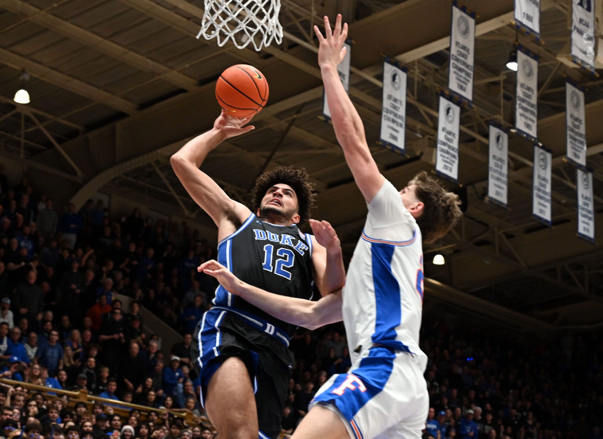 Duke Blue Devils forward Cameron Boozer (12) shoots over Florida Gators forward/center Alex Condon (21) during the second half at Cameron Indoor Stadium.  The Blue Devils won 67-66.