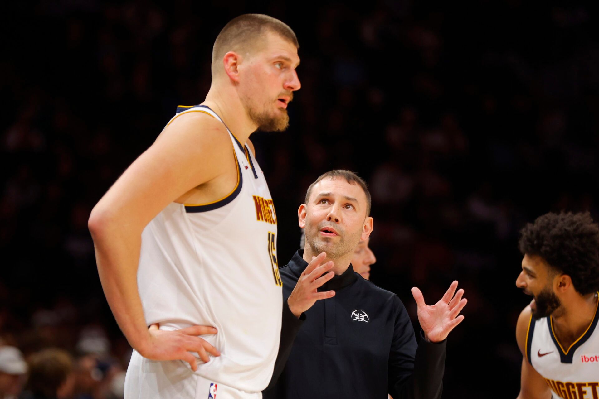 Denver Nuggets head coach David Adelman directs center Nikola Jokic (15) against the Minnesota Timberwolves in the fourth quarter at Target Center.