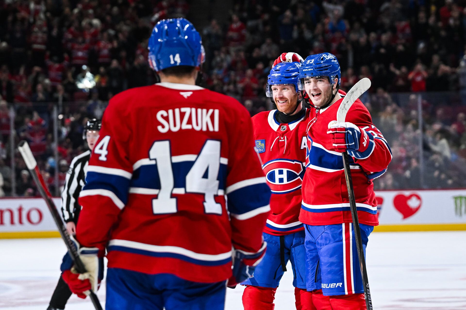 Montreal Canadiens defenseman Noah Dobson (53) celebrates with defenseman Mike Matheson (8) and center Nick Suzuki (14) his goal against the St. Louis Blues during the third period at Bell Centre.